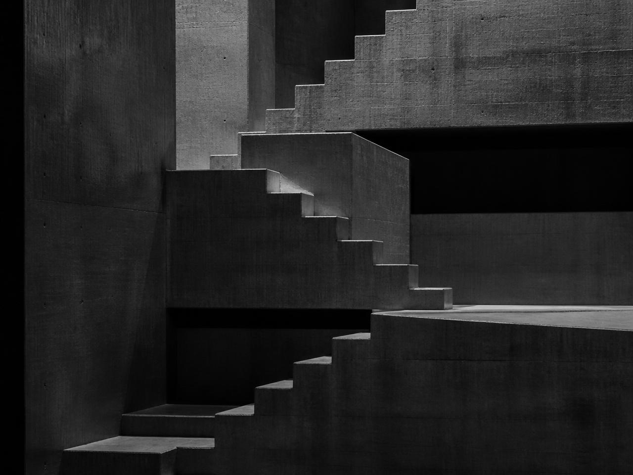 Dark concrete structure with stepped geometry