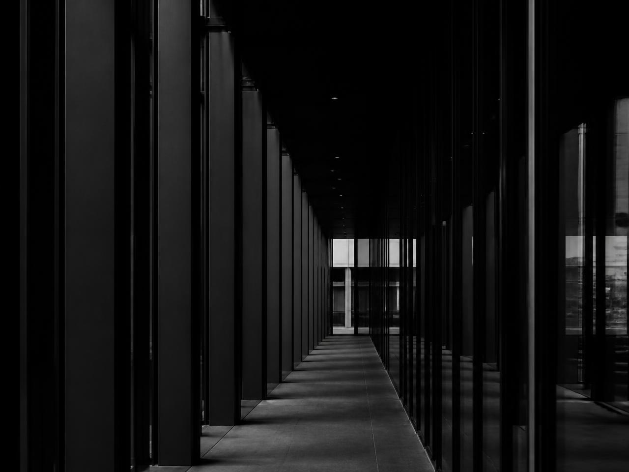 Minimal steel and glass corridor in low light